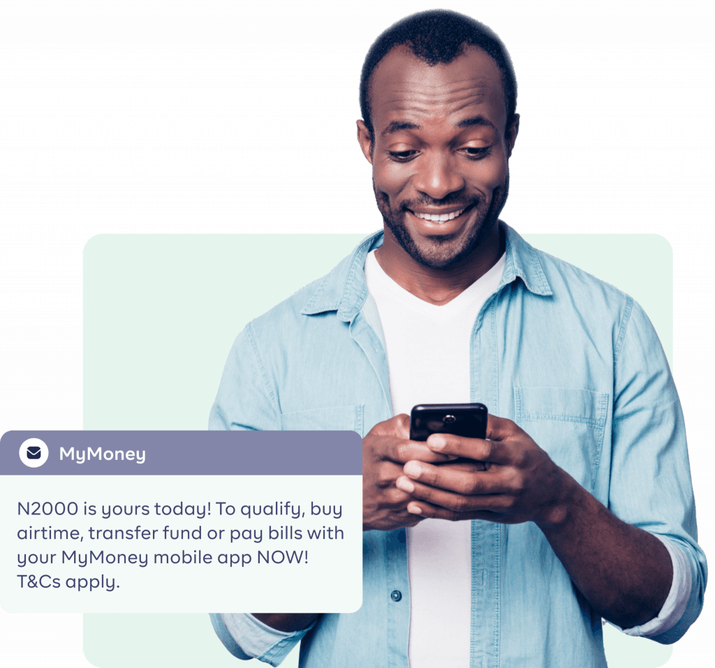 An image of a Black man pressing his phone and smiling