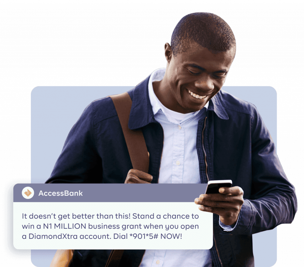 An image of a man smiling and receiving a message from his bank