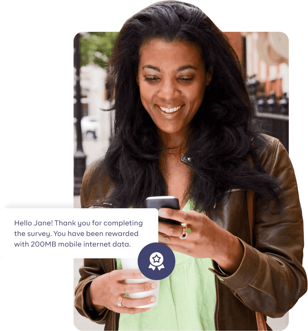 Image of a woman pressing her phone and smiling